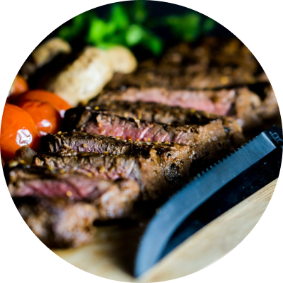 Grilled steak with vegetables on a cutting board